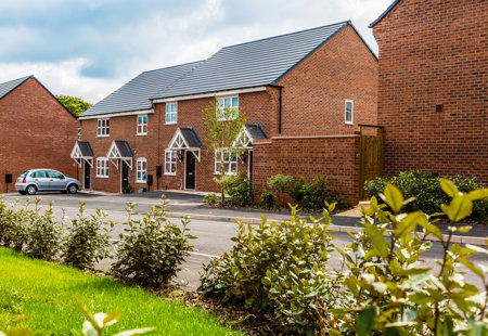 Exterior shot of four homes at Hackwood Park