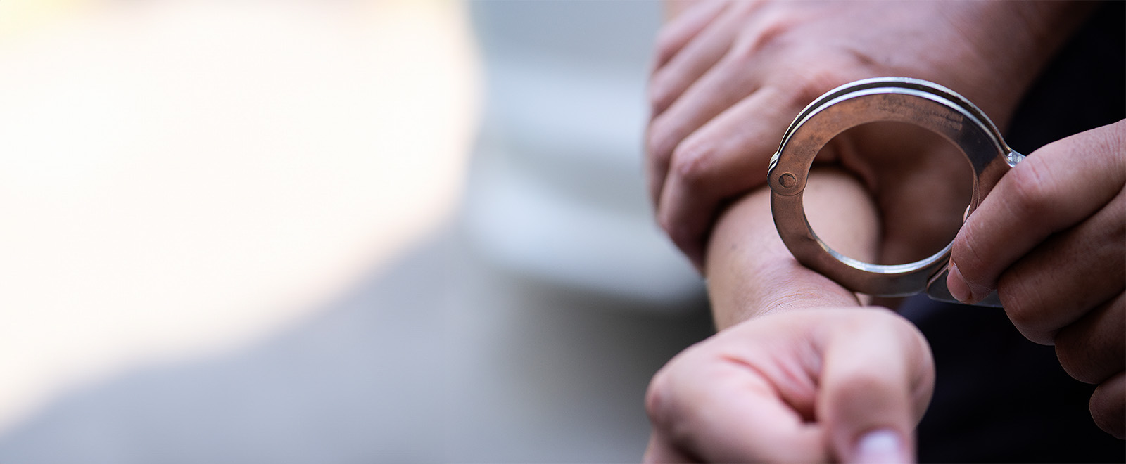Person In Handcuffs Banner