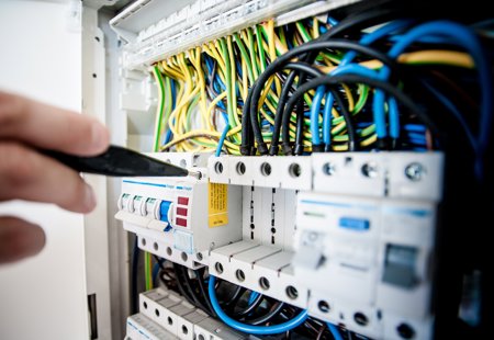 A close up of repairs being done on a telephone circuit board.