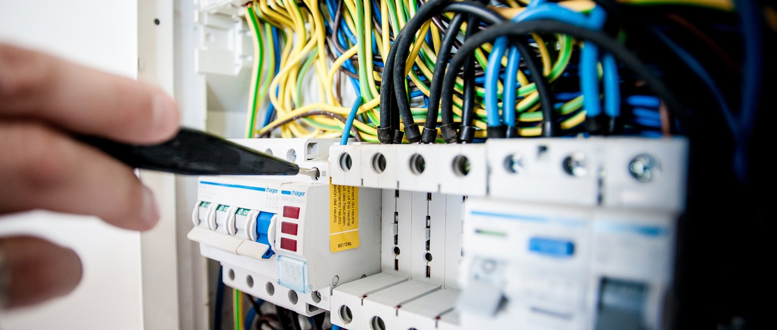 A close up of repairs being done on a telephone circuit board.