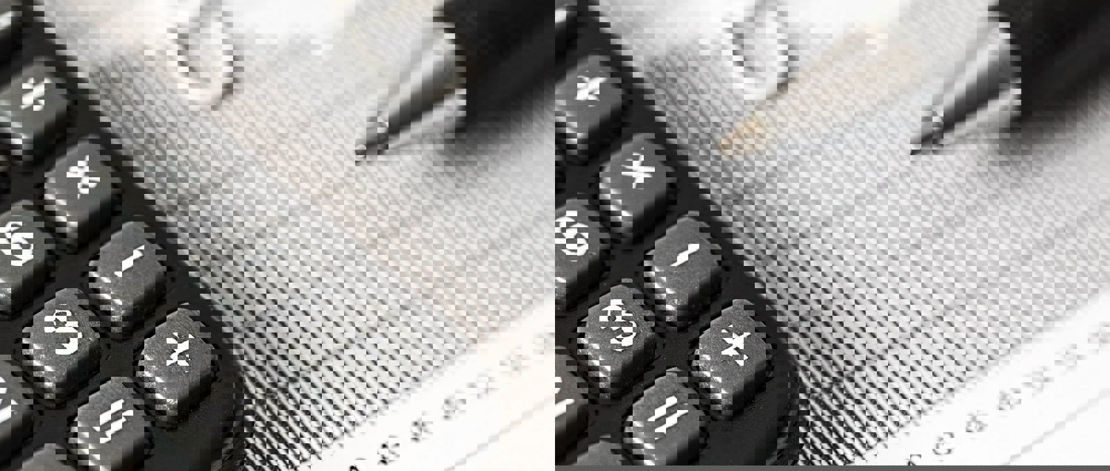 Close up shot of a calculator and a pen on top of a printed chart