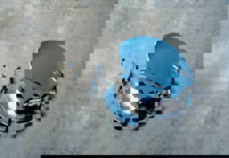 Blue ceramic plate broken on a grey concrete floor