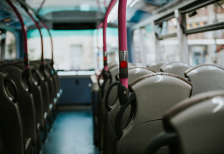 Photo of the inside of a bus, showing a row of seats