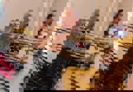 A man in a black shirt playing the trumpet.