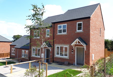 A block of semi-detached houses on a sunny day