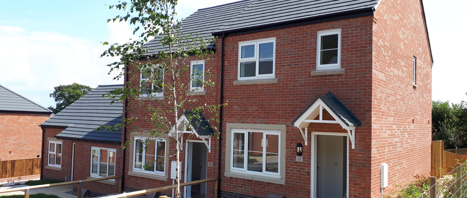 A block of semi-detached houses on a sunny day