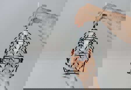 A close up of a man changing a light bulb