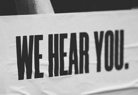 Photo of a banner that reads 'We hear you'