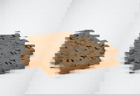 Photograph of wooden tiles spelling out 'Be the kind one'