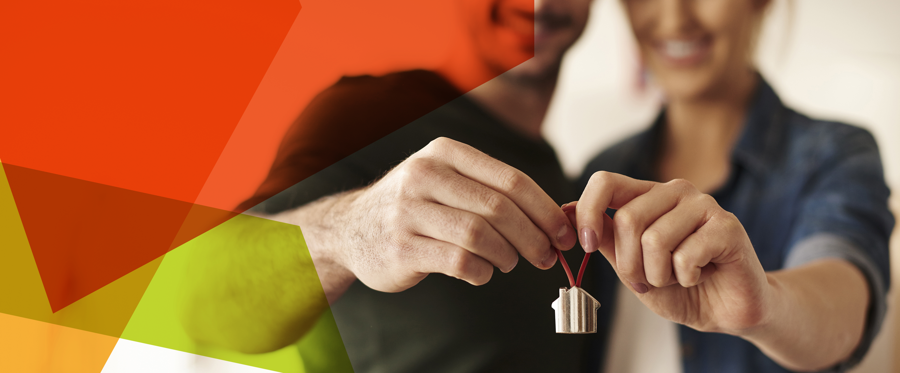 Photograph of a man and woman with arms extended towards the camera and jointly holding a small house-shaped keyring