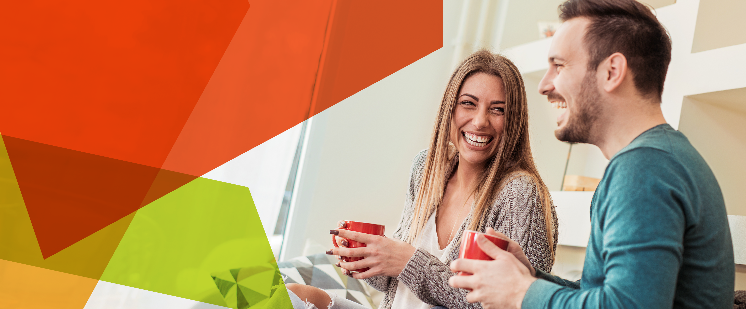 Photograph of a young man and woman holding cups in a domestic setting
