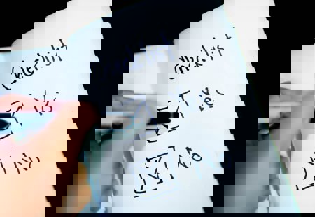 close-up photo of someone about to tick one of two boxes in a notebook marked 'yes' and 'no'