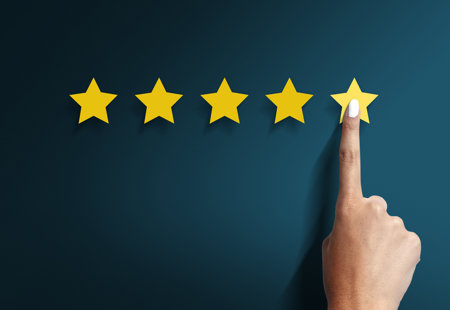 Five yellow stars on a dark blue background with a finger on the fifth star