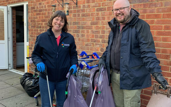 Photo of two of the clean-up day team with their rubbish collection kit