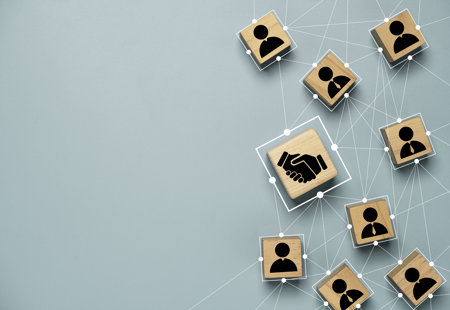 Nine business themed wooden blocks connected by lines on a blue background. 
