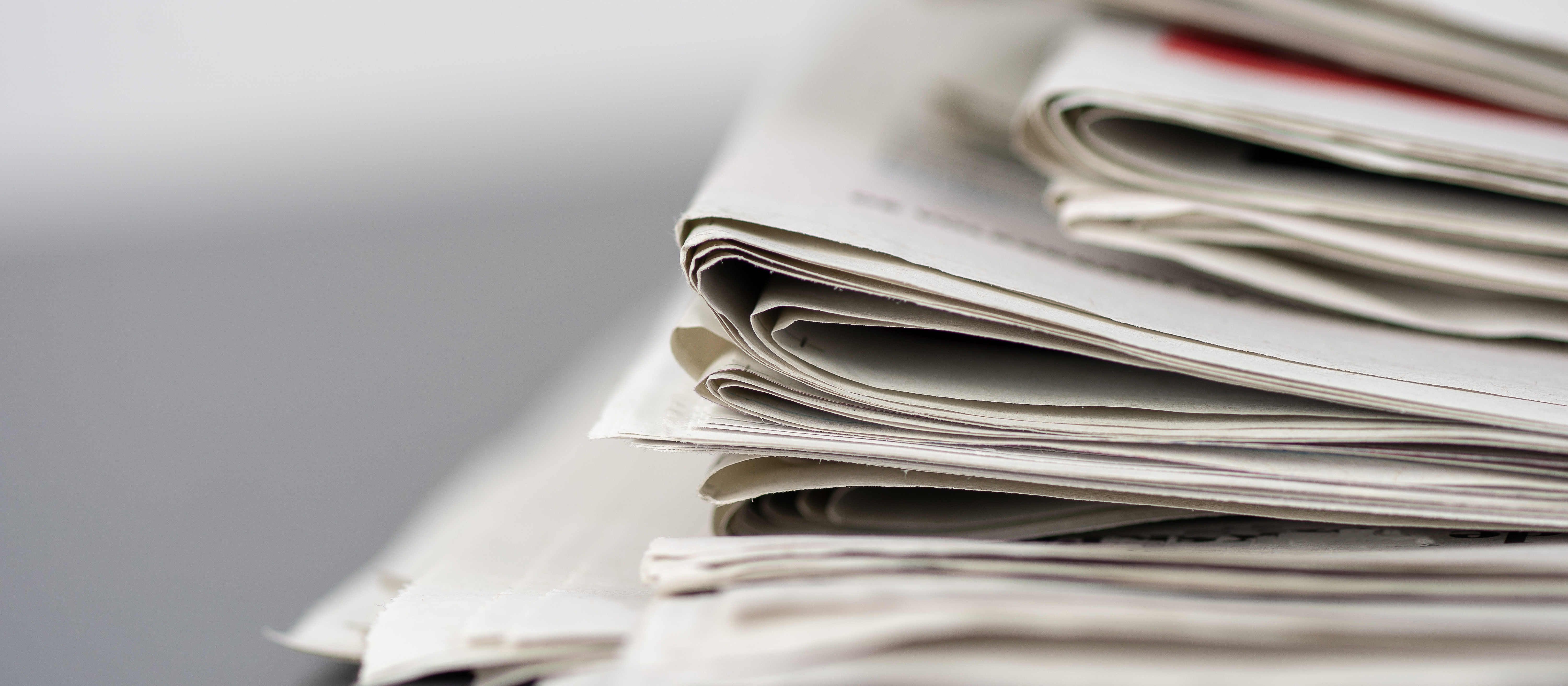 close-up photo of a stack of newspapers