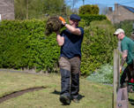 Man holding roll of grass