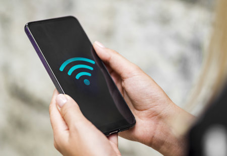 Close Up Phone Hands With Wifi Symbol