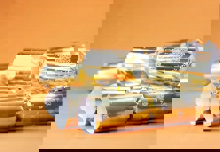 Gold Christmas crackers on an orange background